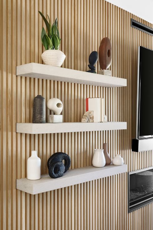 Nord Slat Wood Wall Panel on an Accent Wall with a Floating Shelf and Wall Decorations